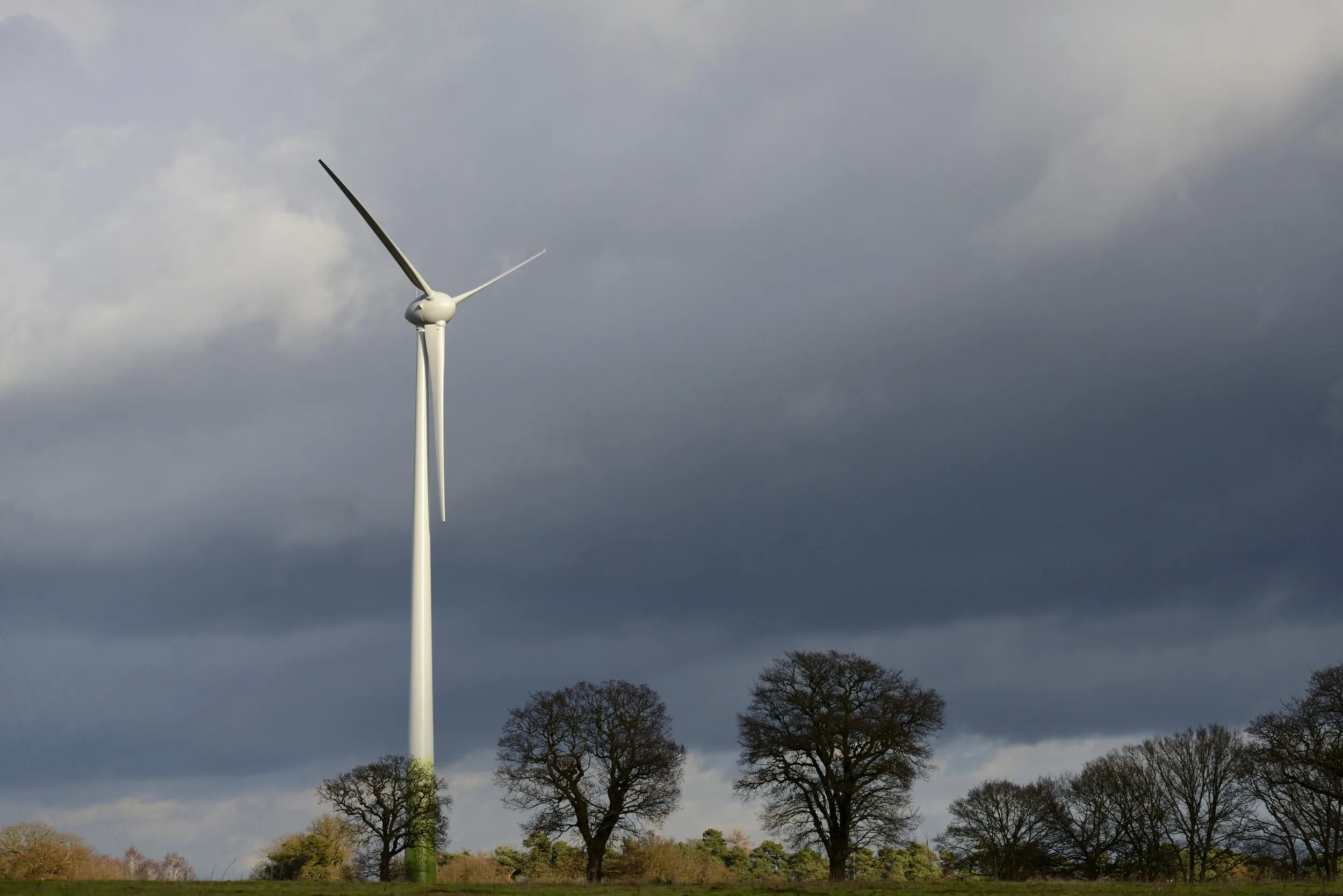 A wind turbine against a stormy sky.