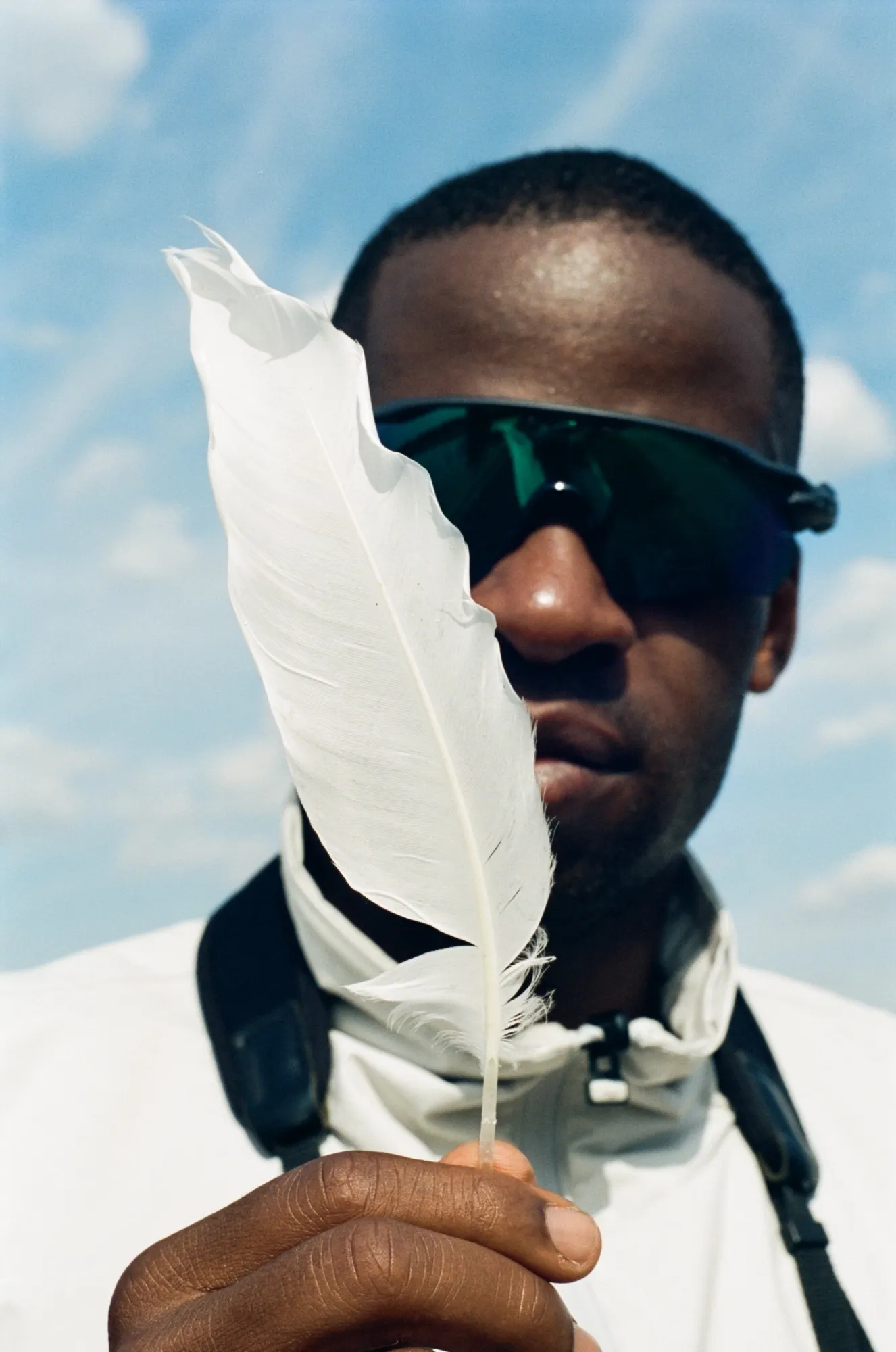 Ollie Olanipekun posing with a feather.