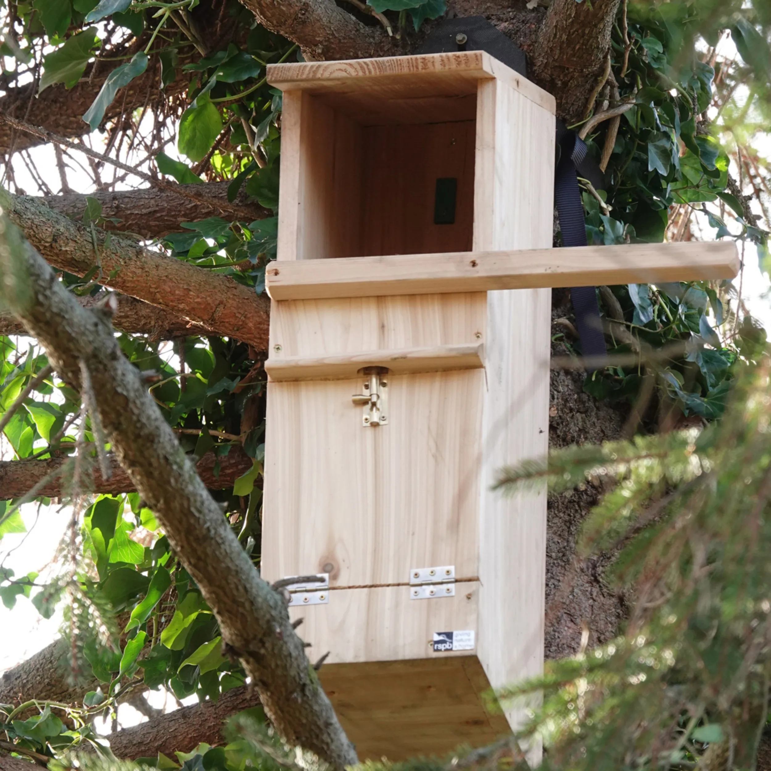 A large wooden Tawny Owl nestbox installed on a tree.